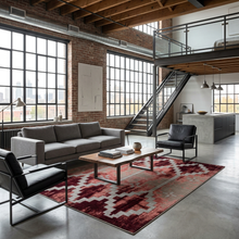 Load image into Gallery viewer, Modern living room with gray sofa, black chairs, and a red patterned rug.

